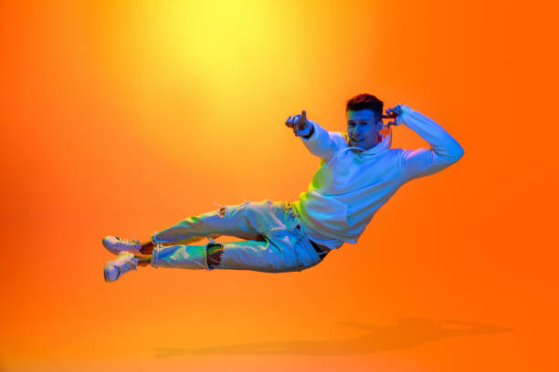 istock Caucasian beautiful man's portrait isolated on yellow studio background in multicolored neon light 1301428721