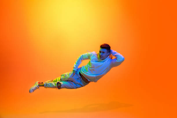 istock Caucasian beautiful man's portrait isolated on yellow studio background in multicolored neon light 1301428726