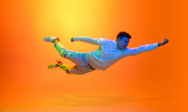 istock Caucasian beautiful man's portrait isolated on yellow studio background in multicolored neon light 1301428739