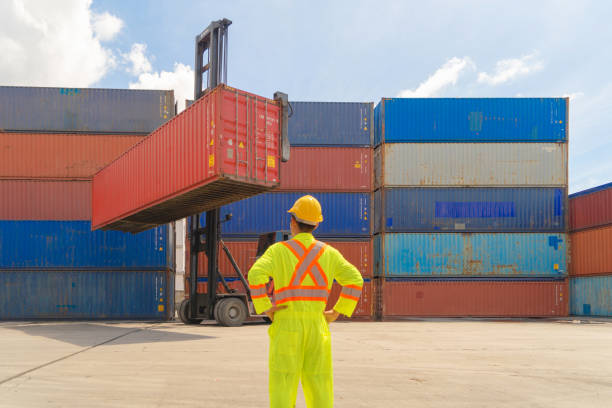 istock Asian logistic worker engineer man working in cargo container warehouse industry factory site in export, import, and transportation concept. Business people lifestyle. Distribution service. 1301428963