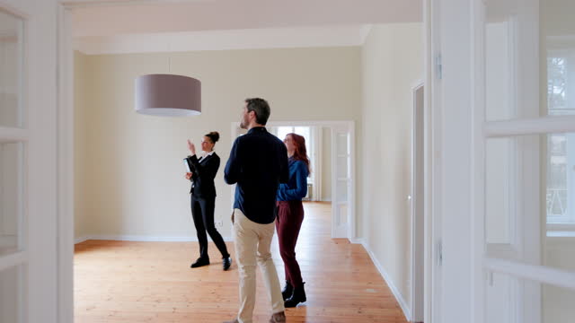 Agent making tour of new home for a couple