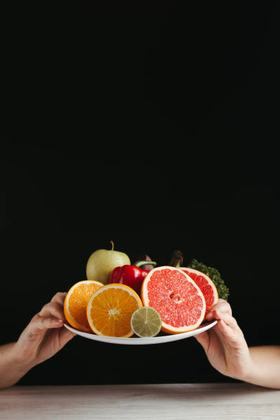 istock Hands holding plate with fresh healthy food 1301430475
