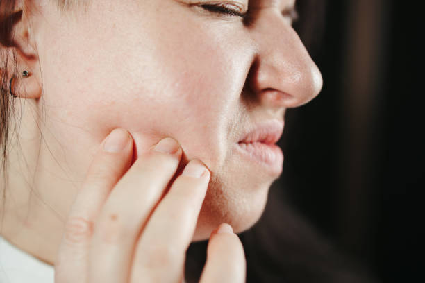 istock Woman touching mouth because of toothache 1301430549