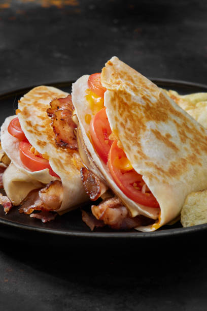 istock The Folded Tortilla Wrap with, Rosted Chicken, Bacon, Tomato and Cheese 1301430760