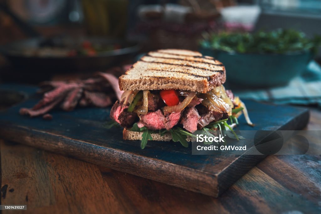 Steak Sandwich with Roasted Bell Pepper and Arugula Sandwich Stock Photo