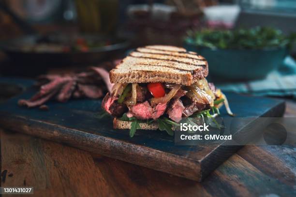 Steak Sandwich With Roasted Bell Pepper And Arugula Stock Photo - Download Image Now