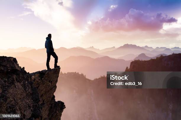 Man Hiker On Top Of A Mountain Peak Stock Photo - Download Image Now - Mountain Climbing, Courage, Adventure