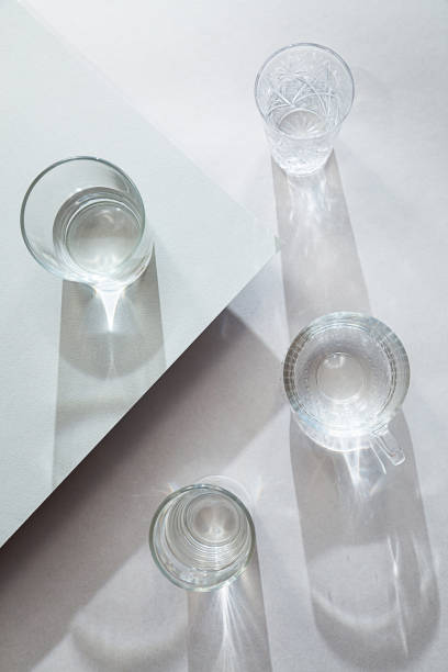 istock Minimal still life with various glasses top view. Modern composition with interesting shadows on a gray table. 1301433533