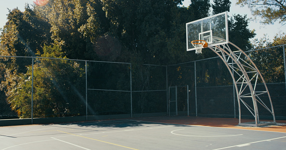 Shot of a basketball hoop on an outdoor court