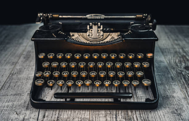 istock Front view of an old vintage typewriter in black on a white table 1301438401