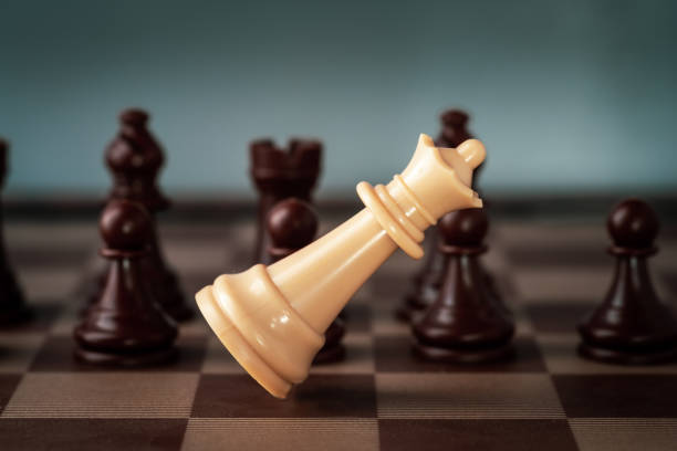 istock white chess queen  falling on chess board concept of failing. 1301439247