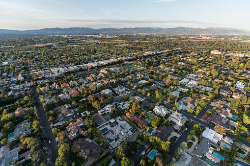 Afternoon aerial view of Encino homes and streets in the San Fernando Valley area of Los Angeles, California.