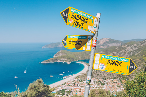 10 September 2020, Oludeniz, Turkey: Lycian Way direction signpost pointing to Babadag and Oludeniz resort