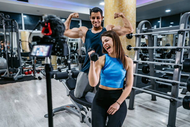 Woman and her trainer making exercise vlog