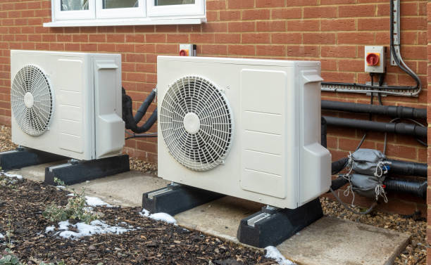 istock Two air source heat pump units for heating a modern home 1301442512