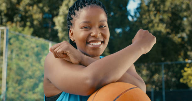 I chose not to have DIS in my ability Cropped shot of a young female basketball smiling at the camera with her arms crossed on the ball disempower stock pictures, royalty-free photos & images
