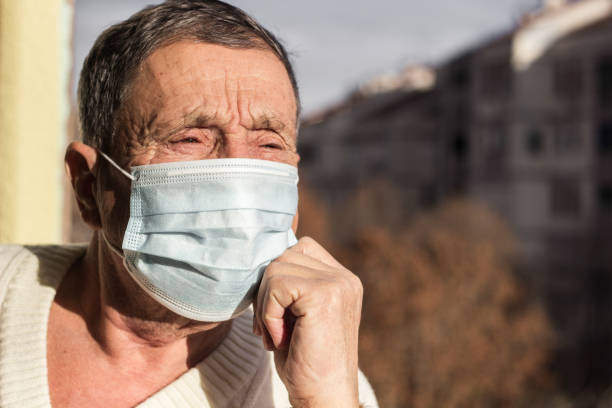 istock Senior man wearing medical facemask 1301446190