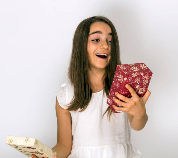 istock A Beautiful Young girl Holding A Gift Box 1301447973