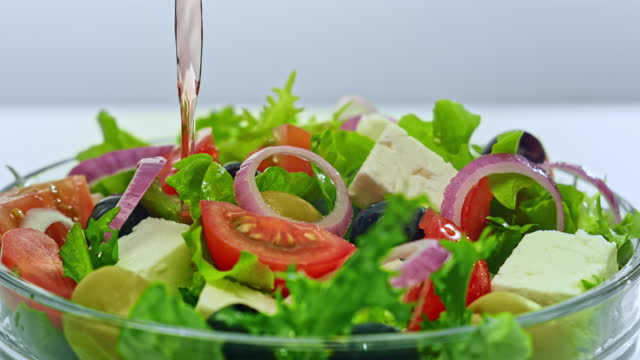 SLO MO Vinegar being poured onto a salad