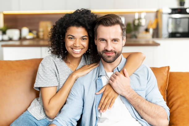 istock Multiracial couple in love on the couch 1301449546