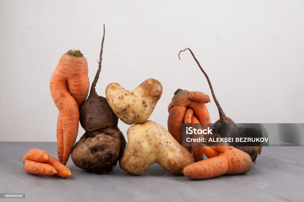 Ugly vegetables, side view, close-up. Concept - Food organic waste reduction. Using in cooking imperfect products Ugly vegetables, side view, close-up. Concept - Food organic waste reduction. Using in cooking imperfect products. Food Stock Photo