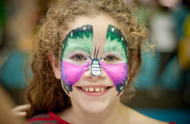 istock girl with butterfly drawing on her face 1301451807