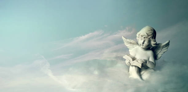 istock Angel sitting on the cloud and reading book 1301452694
