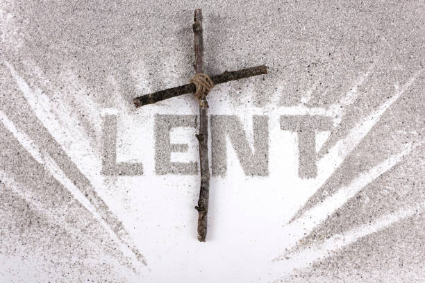 istock Lent word written in ash with Christian Cross. 1301453417