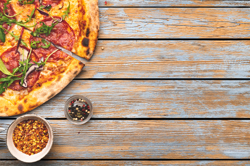 Pepperoni Pizza on wooden table with space on text. Top view