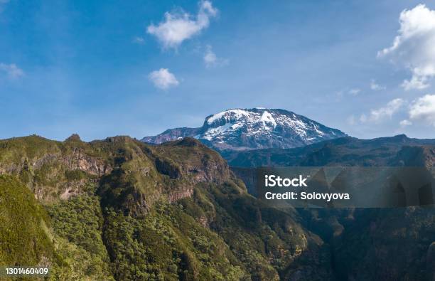 Aerial Shot Of A Highest African Continent Summit Kilimanjaro Uhuru Peak 5895m Volcano Covered With Snows Drone Point Of View Flying Up At Cca 3600m Umbwe Route Tanzanian National Park Stock Photo - Download Image Now