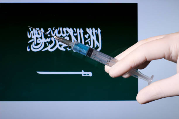 istock Hand holding syringe with covid vaccine 1301460611