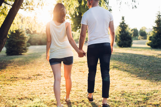 istock Couple Walking And Holding Hands 1301462935
