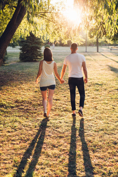 istock Couple Walking And Holding Hands 1301463727