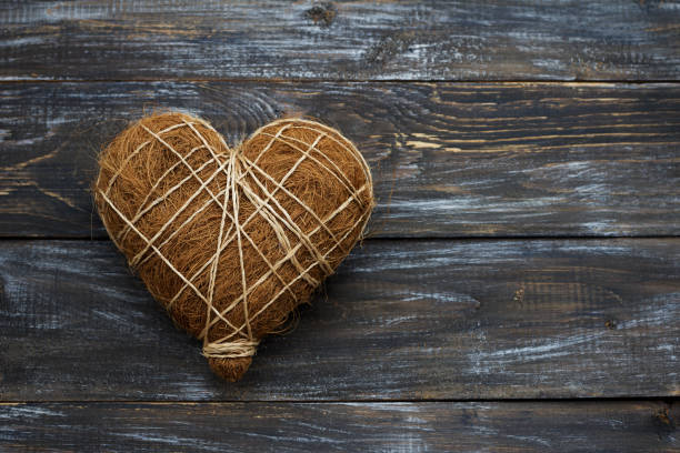 istock Straw heart on wooden background, rustic style 1301464308