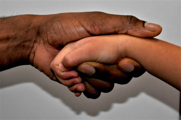 istock Father and child holding hands 1301466460