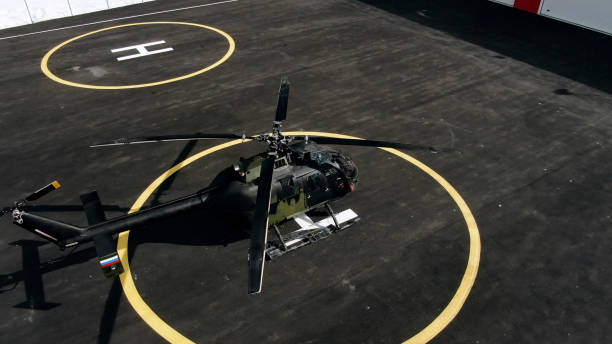 istock Military helicopter at helipad 1301466863