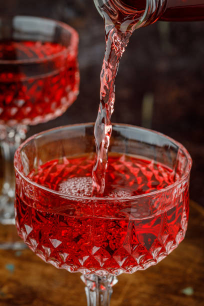 istock Pouring glass of red wine from a bottle. 1301468312