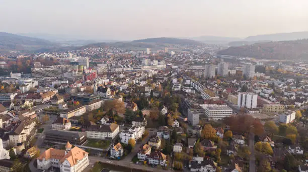 Drone view of cityscape Brugg with residential and commercial districts, historic old town and Windisch in canton Aargau in Switzerland. Town situated on feet of Tafeljura.