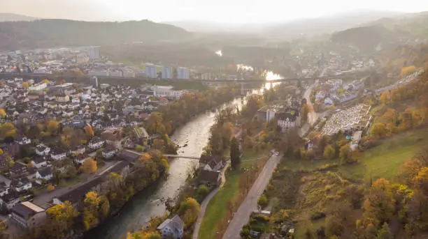 Drone view of city Brugg south-west and Umiken with Aare river, residential districts, bridge and old mill, famous train viaduct in canton Aargau in Switzerland. Town situated on feet of Tafeljura.