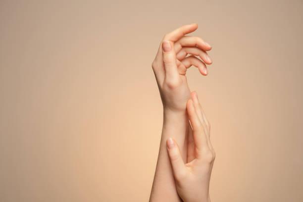 istock A woman's hands close up, on a beige background. 1301471872