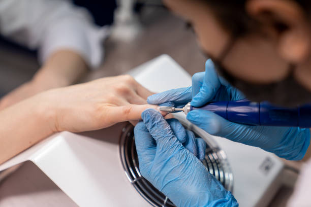 istock manicurist professionally handles nails for his client 1301473083
