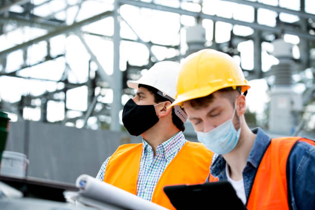 istock Engineers checking electric power station, review blueprints and statistics.. 1301474388