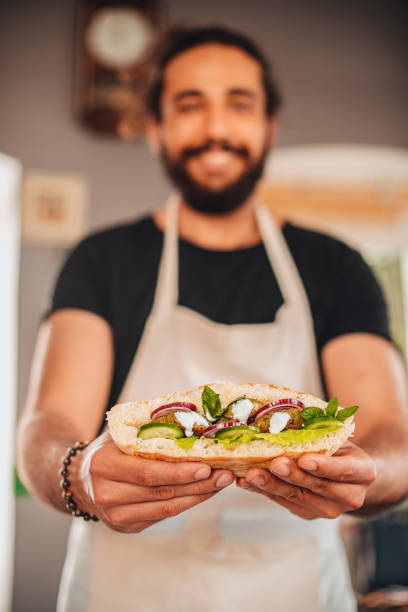 istock Chef Holding a Falafel Sandwich 1301474683