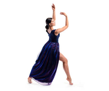 Gymnast in a dress performs a pose of rhythmic gymnastics. Dance element on a white background