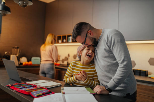 istock Father assisting his child about homework 1301477753