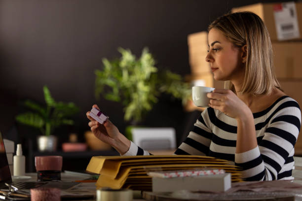 istock Holding a small gift box and sipping coffee 1301477765