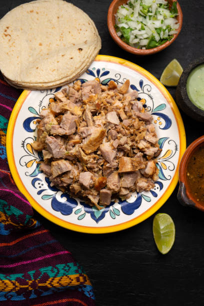 istock Confit pork called carnitas on dark background. Mexican food 1301479604