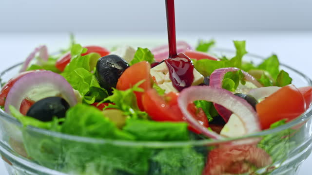 SLO MO Balsamic vinegar being poured onto a salad