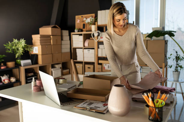 istock Female entrepreneur diligently preparing customer's order 1301479682