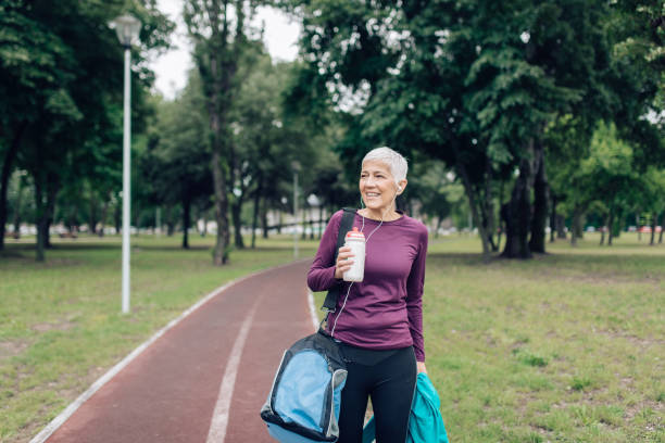 istock Happy mature woman refreshing while coming back from training 1301479795